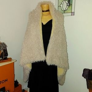 Fuzzy vest like new will fit a medium to an XL .. is oversized and warm and soft